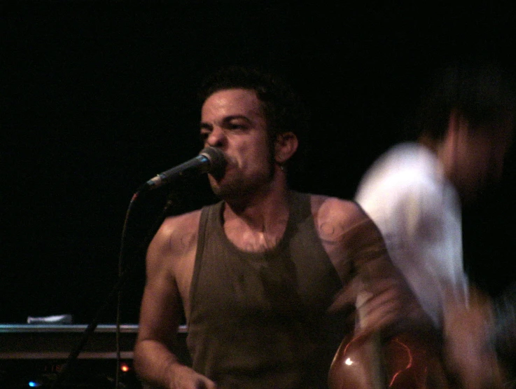 a man that is standing in front of a microphone