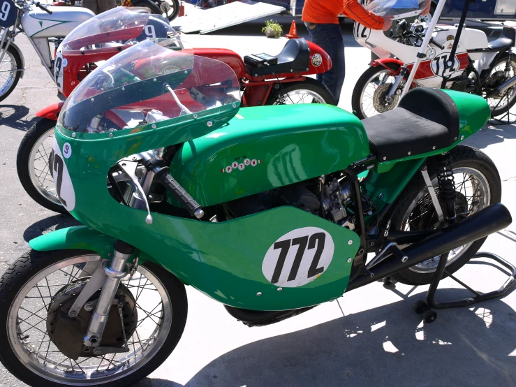 a green motorcycle that is parked in a lot