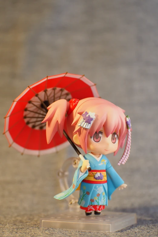 there is a toy doll that has an umbrella on it