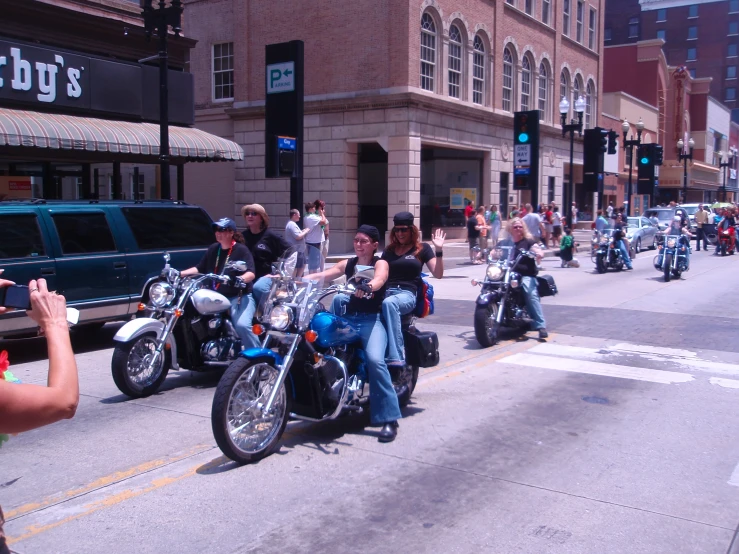 motorcycle riders are lined up in the street