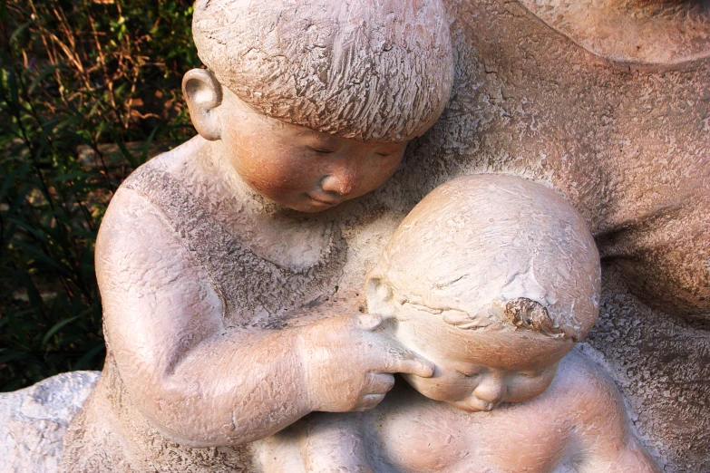 a statue is shown holding a child