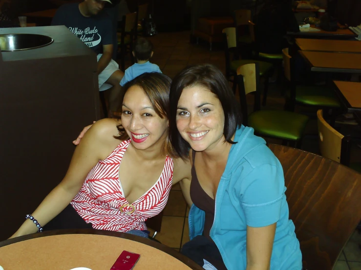 two women posing for a po together at a restaurant