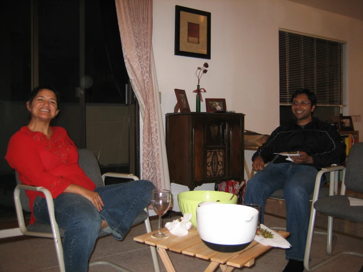 two people sitting next to each other in a living room