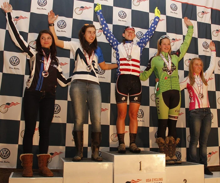 a group of people on podiums with their hands up