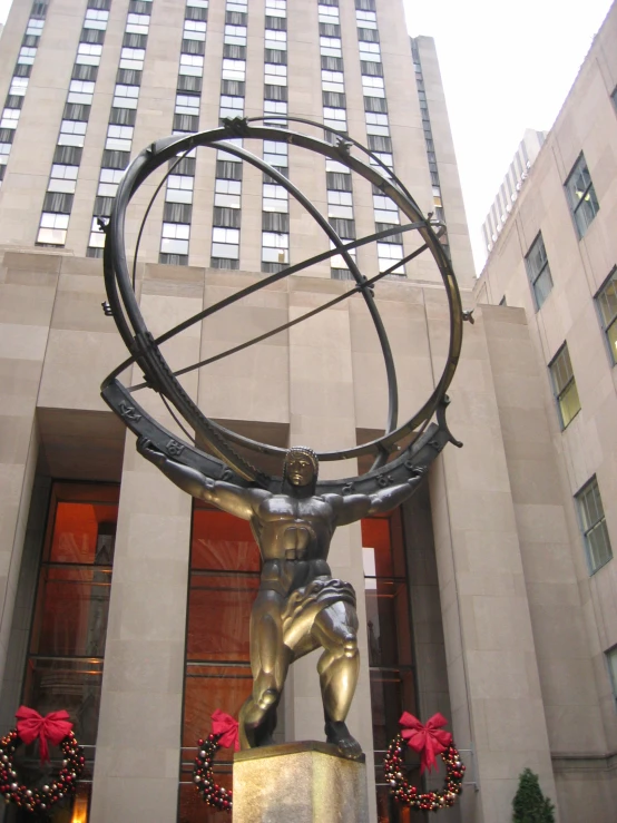 a sculpture with an arrow in it that holds the globe