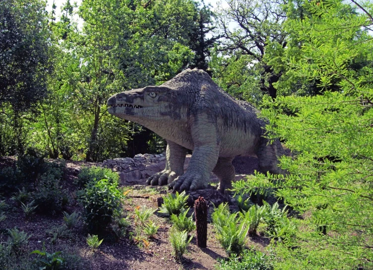 a large dinosaur statue that is in a forest