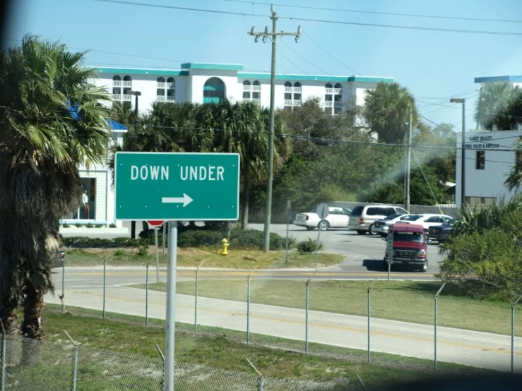 a green down under sign on the side of a road