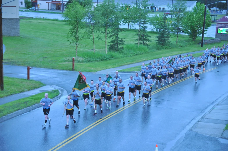 a parade of athletes in a city street