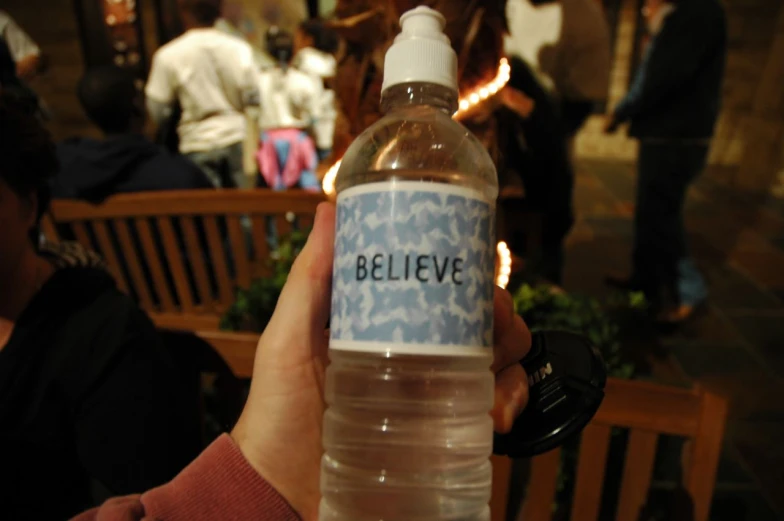 a bottle of water with the words believe on it
