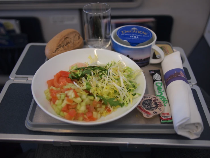 a meal is served with bread and drinks on the tray