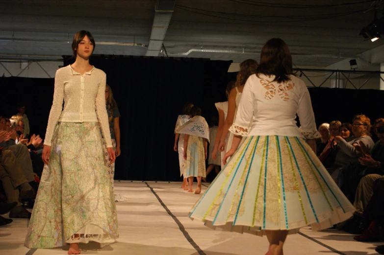 women walking down a runway at a fashion show