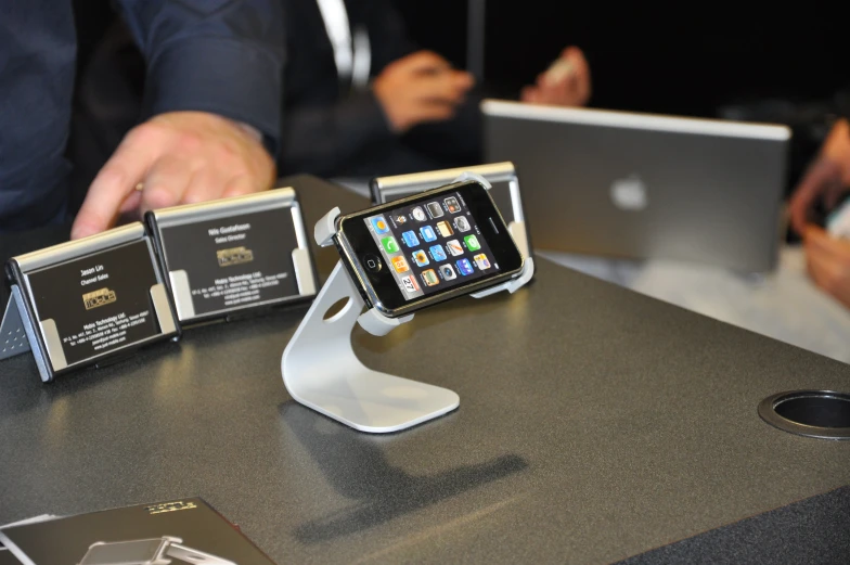 a cell phone and some cards sitting on a table