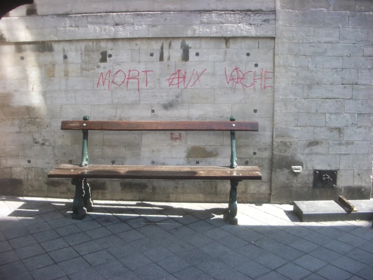 a wooden bench on a city sidewalk