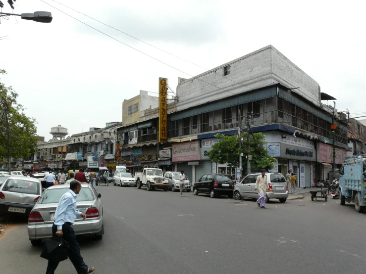 the street is busy with people and vehicles