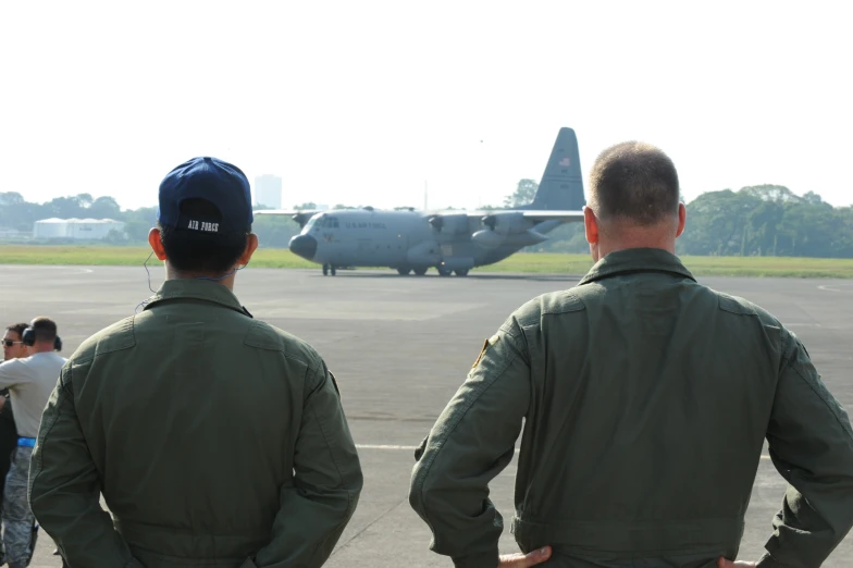 three pilots watch the flight as they prepare for takeoff