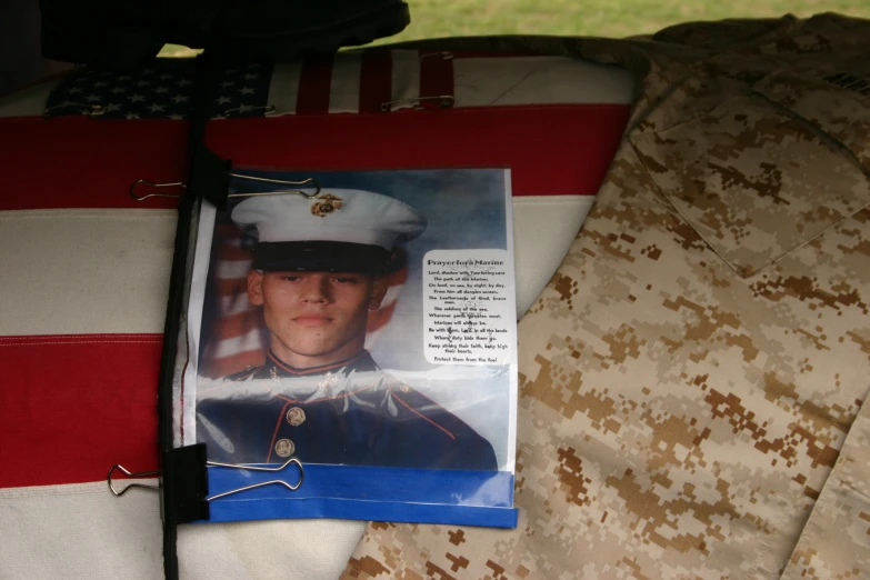 a poster with a picture of an american soldier is laying beside a pillow