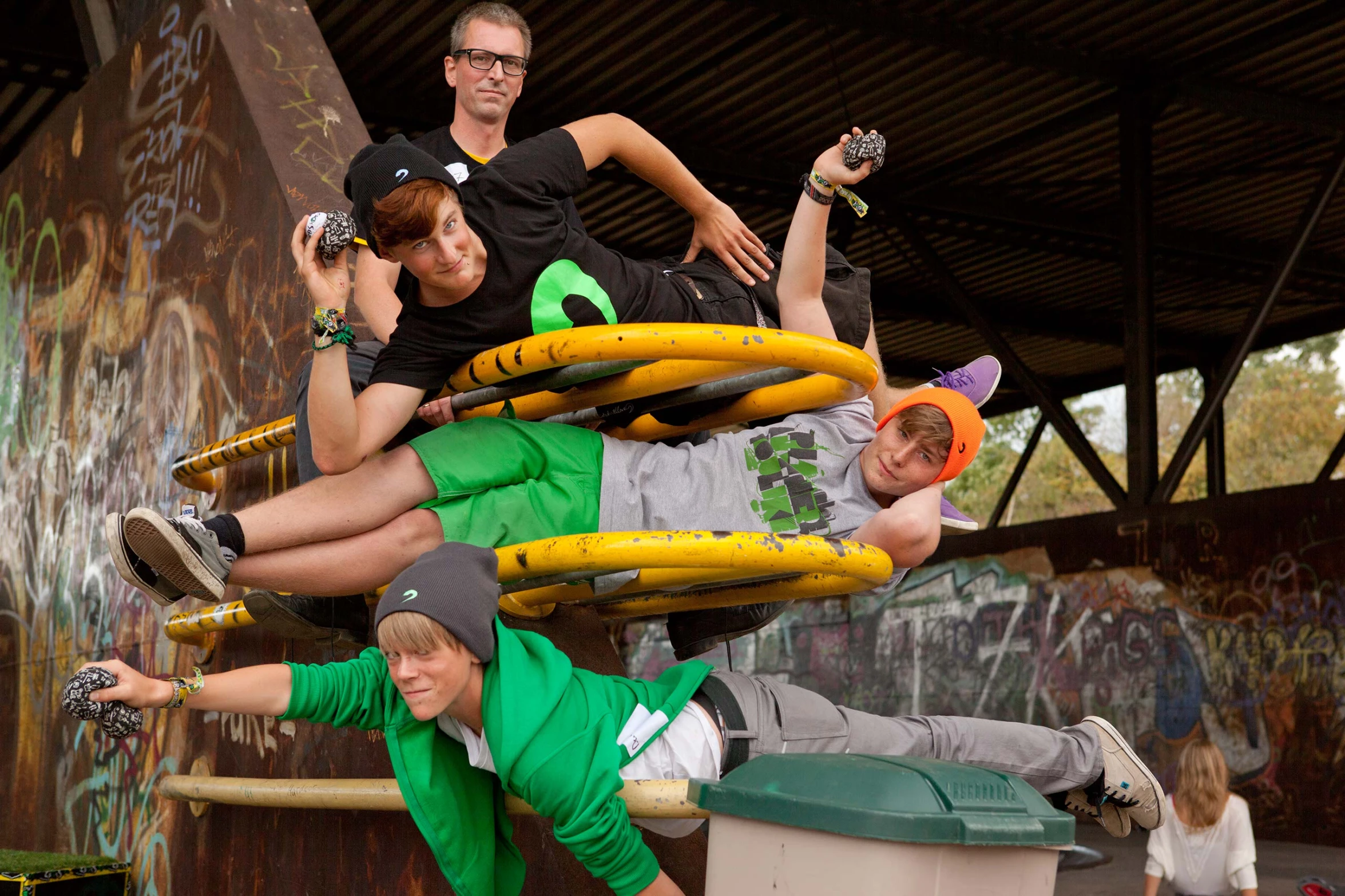 three young men climbing up a plastic water slide