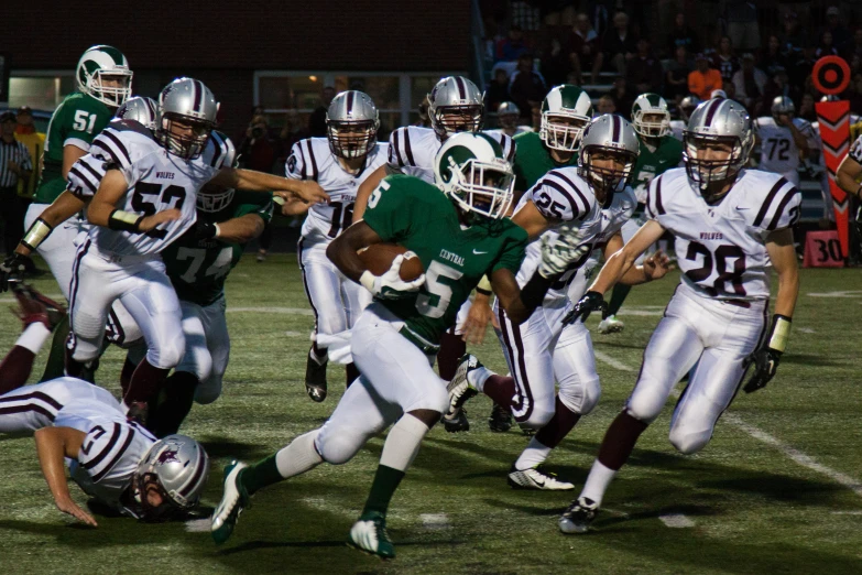 the football players are playing on the field