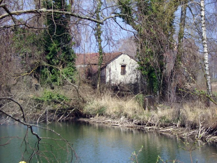 a building is standing alone in the middle of a stream