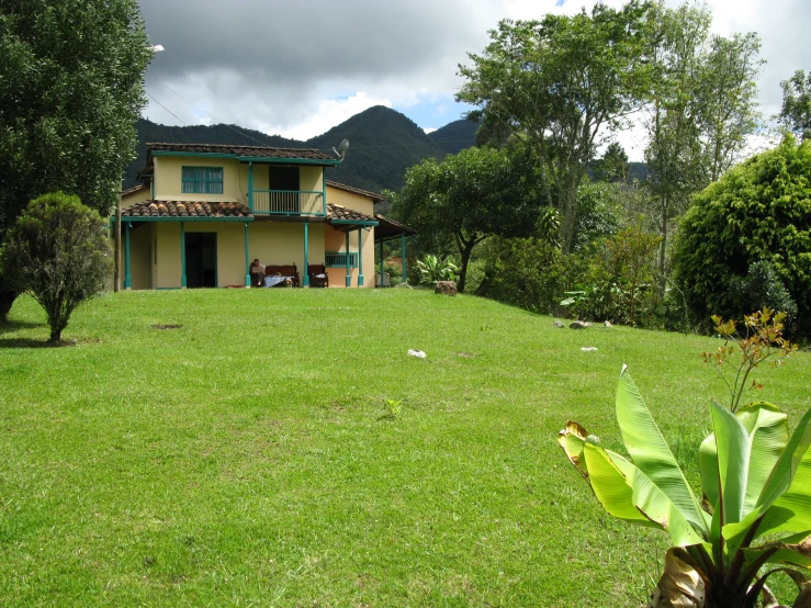 a house sitting on top of a lush green field