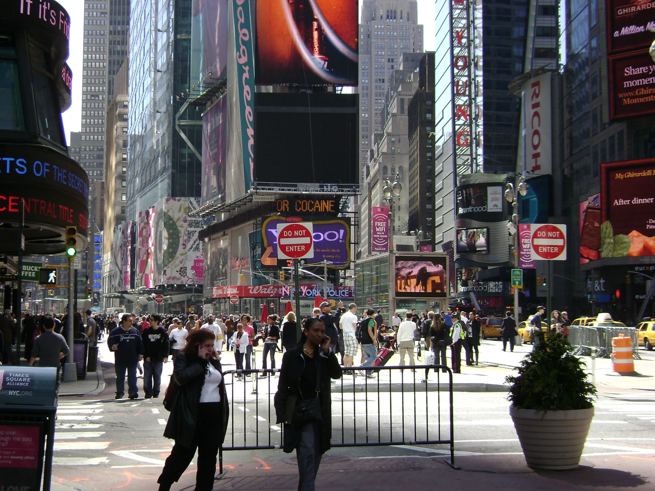 pedestrians walking in a city street on a sunny day