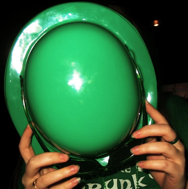 green plate being held by woman's hands