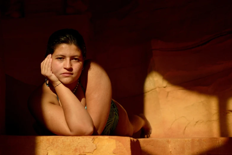 a girl sitting in the corner of a wall