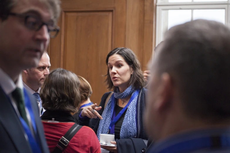 a woman is standing between several other people