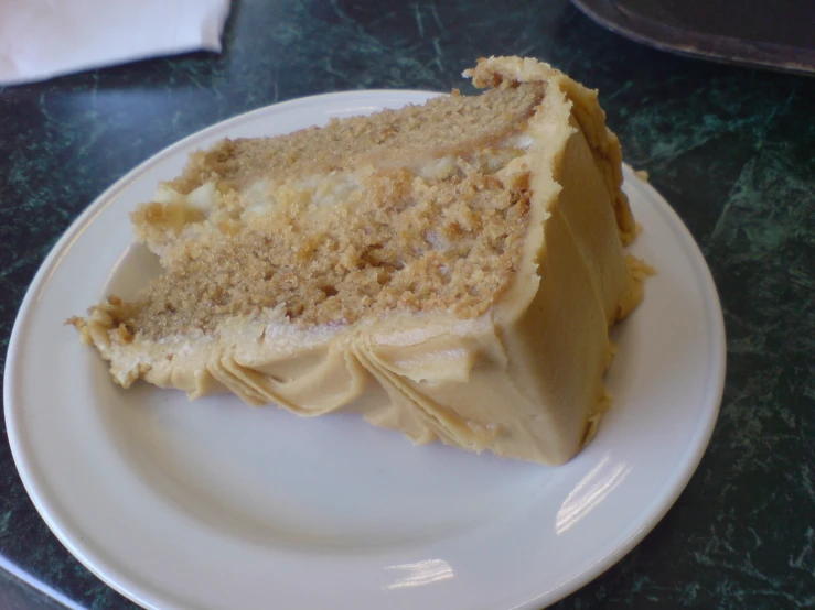 a piece of cake with some brown toppings on a white plate