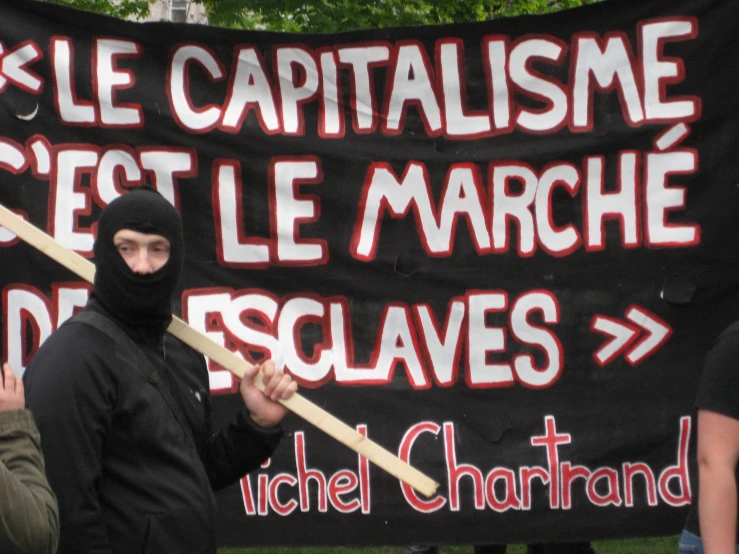 there are protesters holding up a political banner