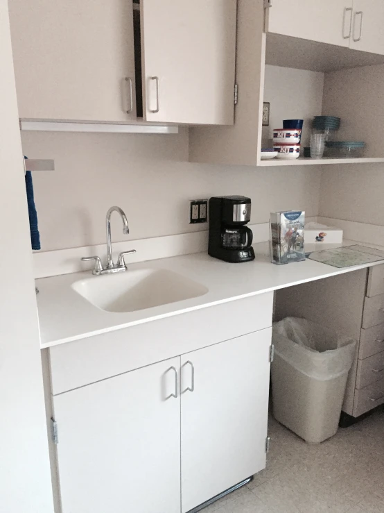 a white kitchen with cabinets and an organized refrigerator