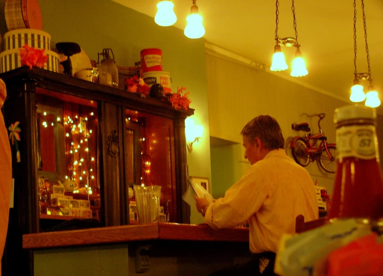 a bar with a man at the counter in front of it