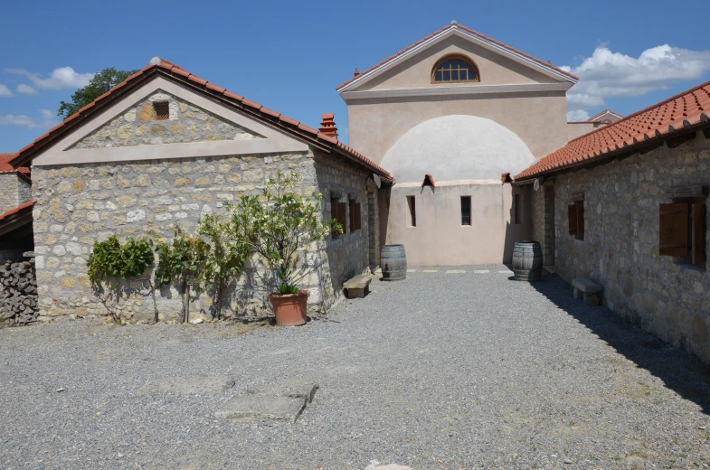 an old courtyard has stone buildings and brick