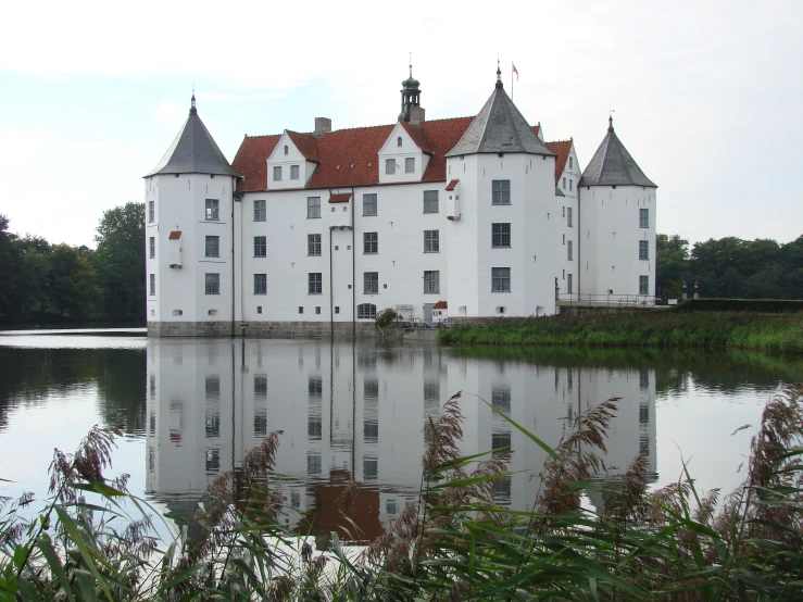 a water front view of an old castle next to a lake