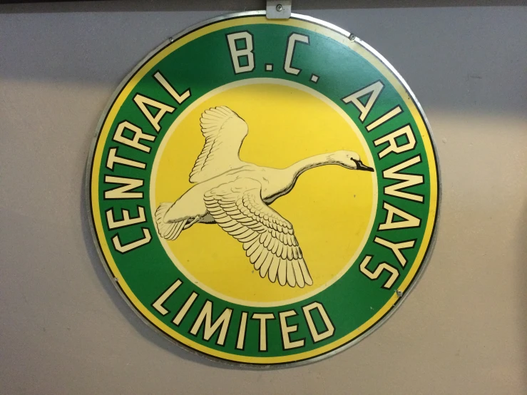 the circular emblem sign on the wall for central b c airport