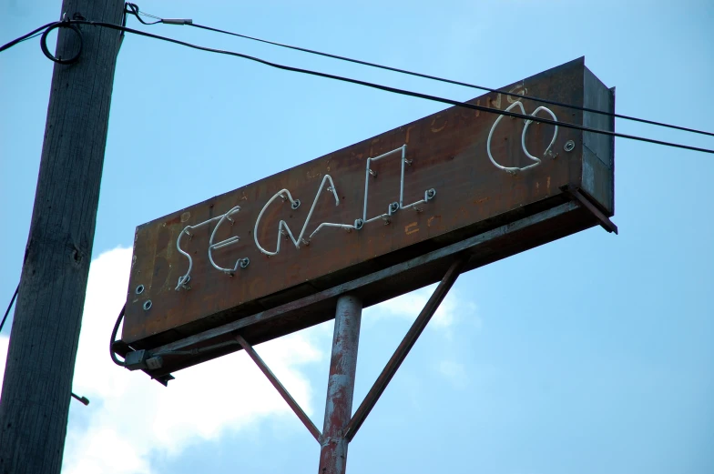 an old rusty sign that reads sequac co