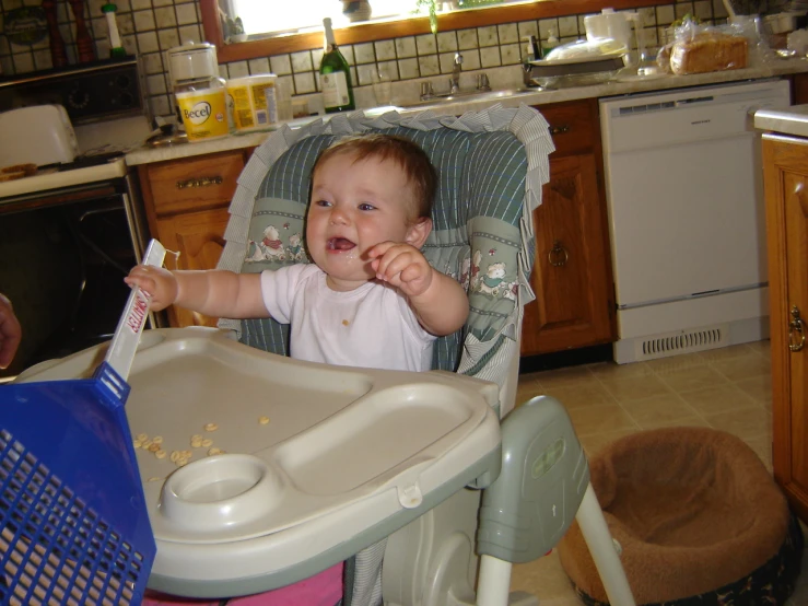 a baby eating oats of food from his high chair