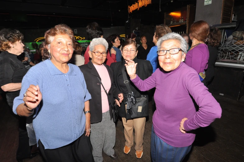 a group of older women are on a dance floor