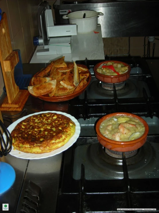 various dishes of food are sitting on the stove