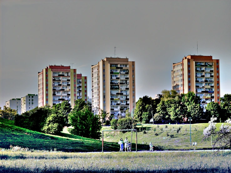 some tall buildings with trees around them