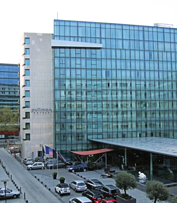 a view of a large building with several cars parked in front