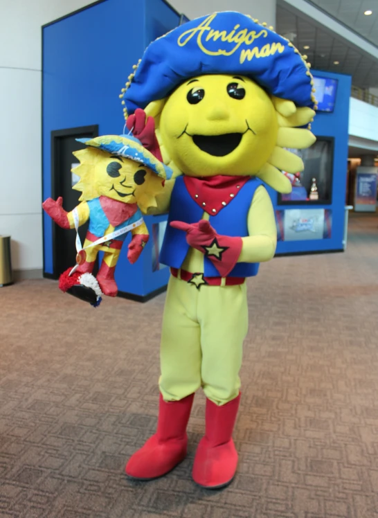the mascot and a child are standing in a room
