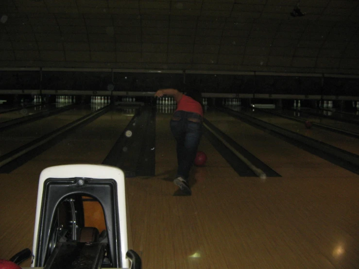a person standing up at the back of a bowling alley