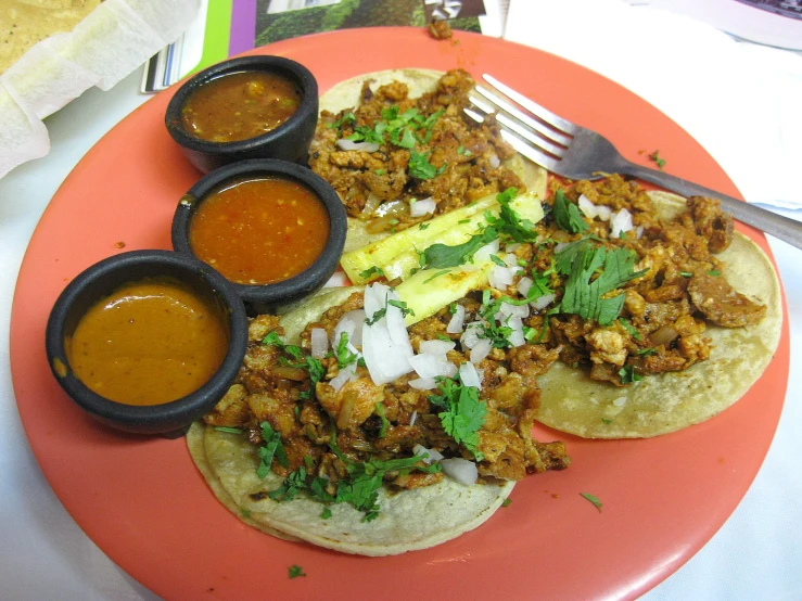 some food is placed on a plate with spoons