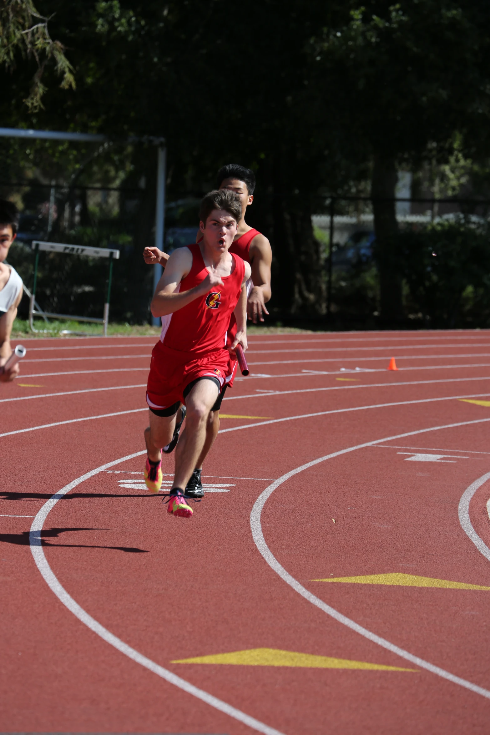 several children running on the race track with a tennis racket