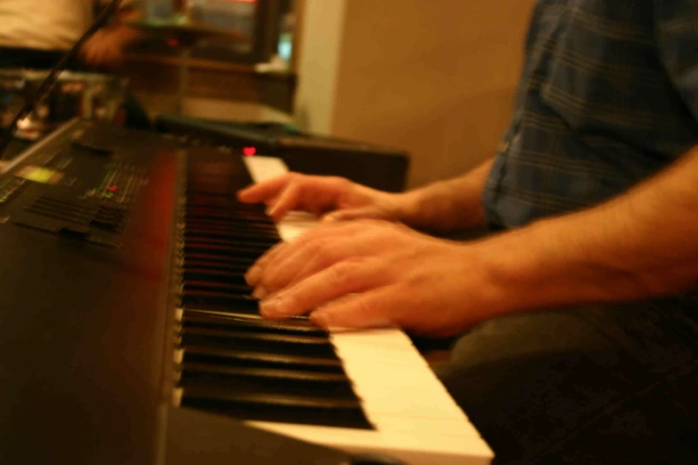 a man holding an electronic keyboard in one hand