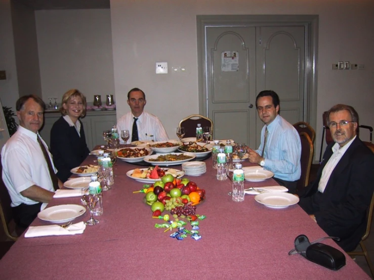 the men sitting around the table are posing for a po