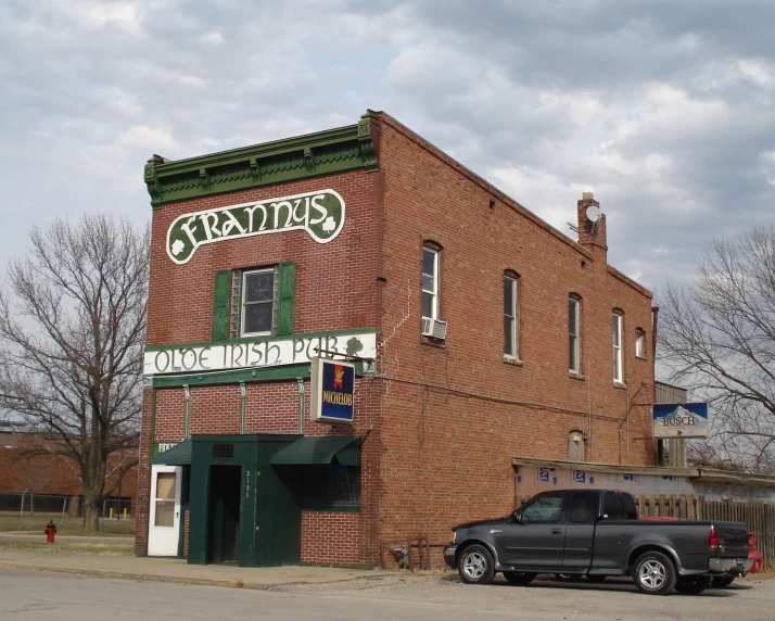 an old brick building is displaying antiques in its facade