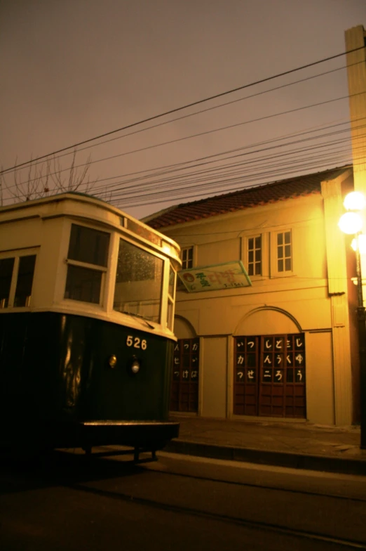 a trolley parked at the curb on an empty street