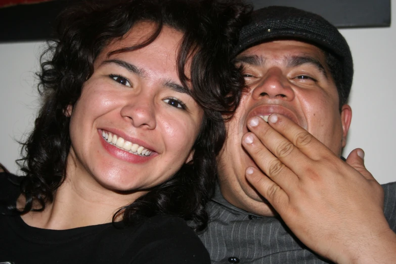 a man and woman all smiling in the same room